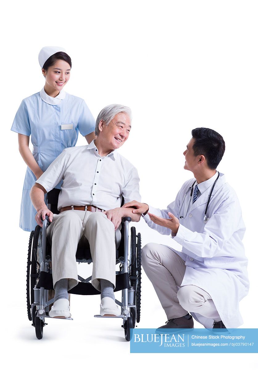 Chinese doctor, nurse with wheelchair bound patientHighres stock