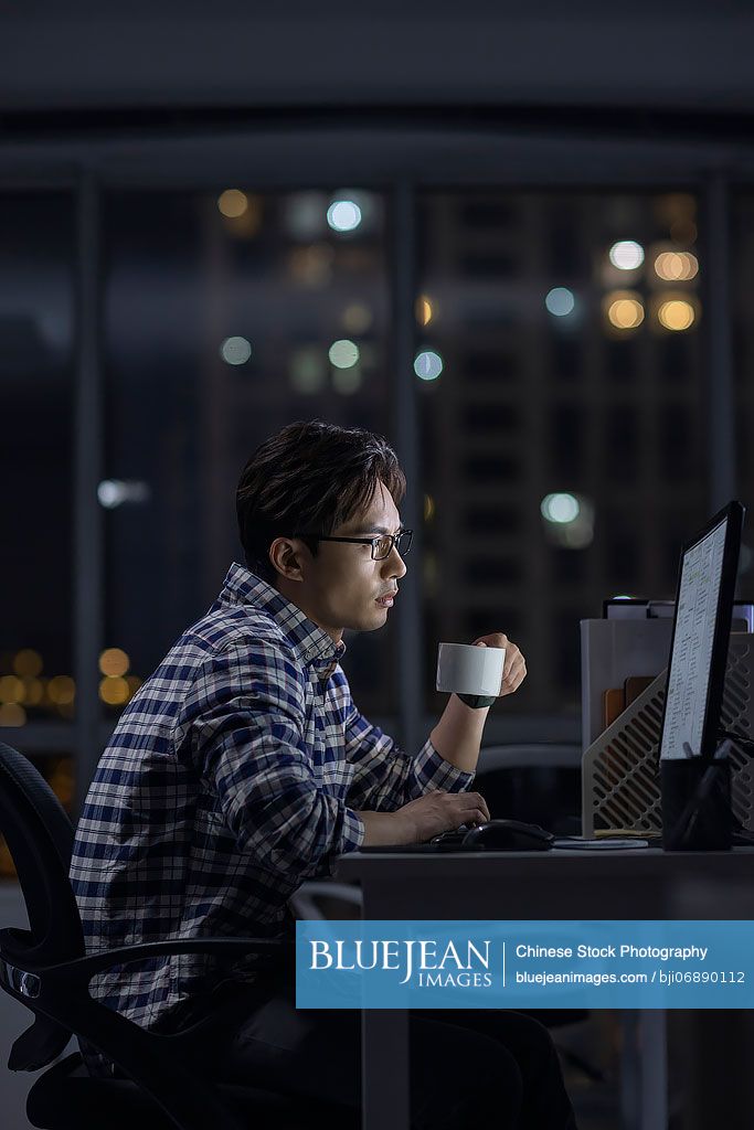 Chinese IT worker working in office at night-High-res stock photo for ...