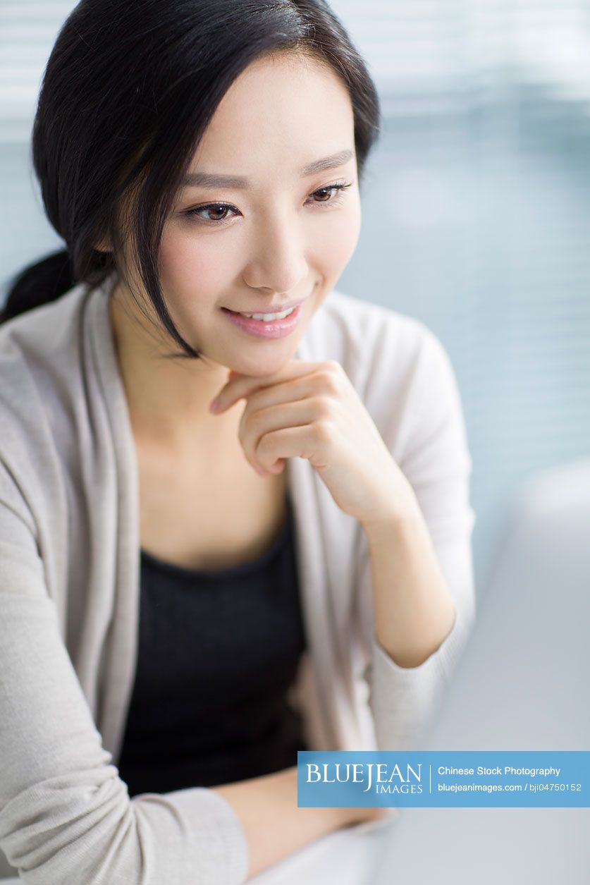 Young Chinese woman working in office