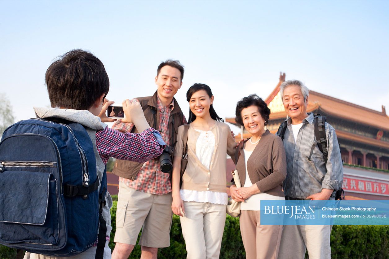 Happy Chinese family travelling at Tiananmen Square in Beijing, China