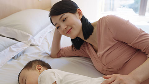 Young pregnant Chinese woman with her child