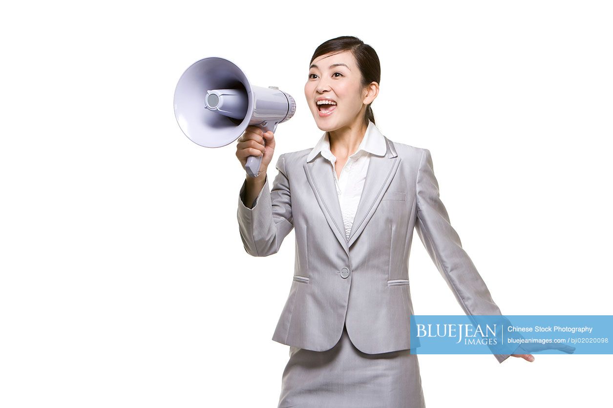 Chinese businesswoman shouting with megaphone