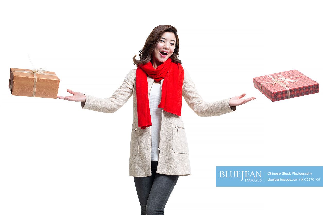 Happy young Chinese woman receiving gifts