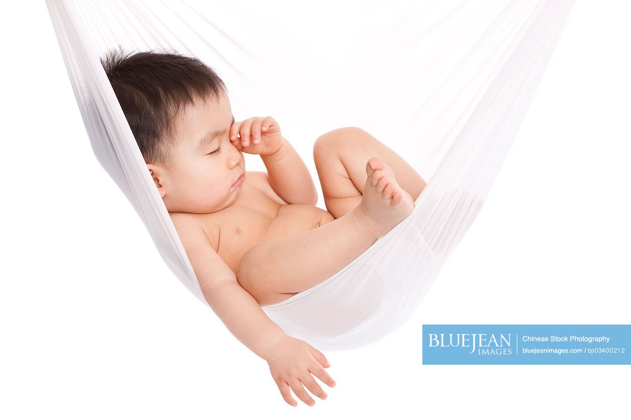 Cute Chinese baby boy sleeping in hammock