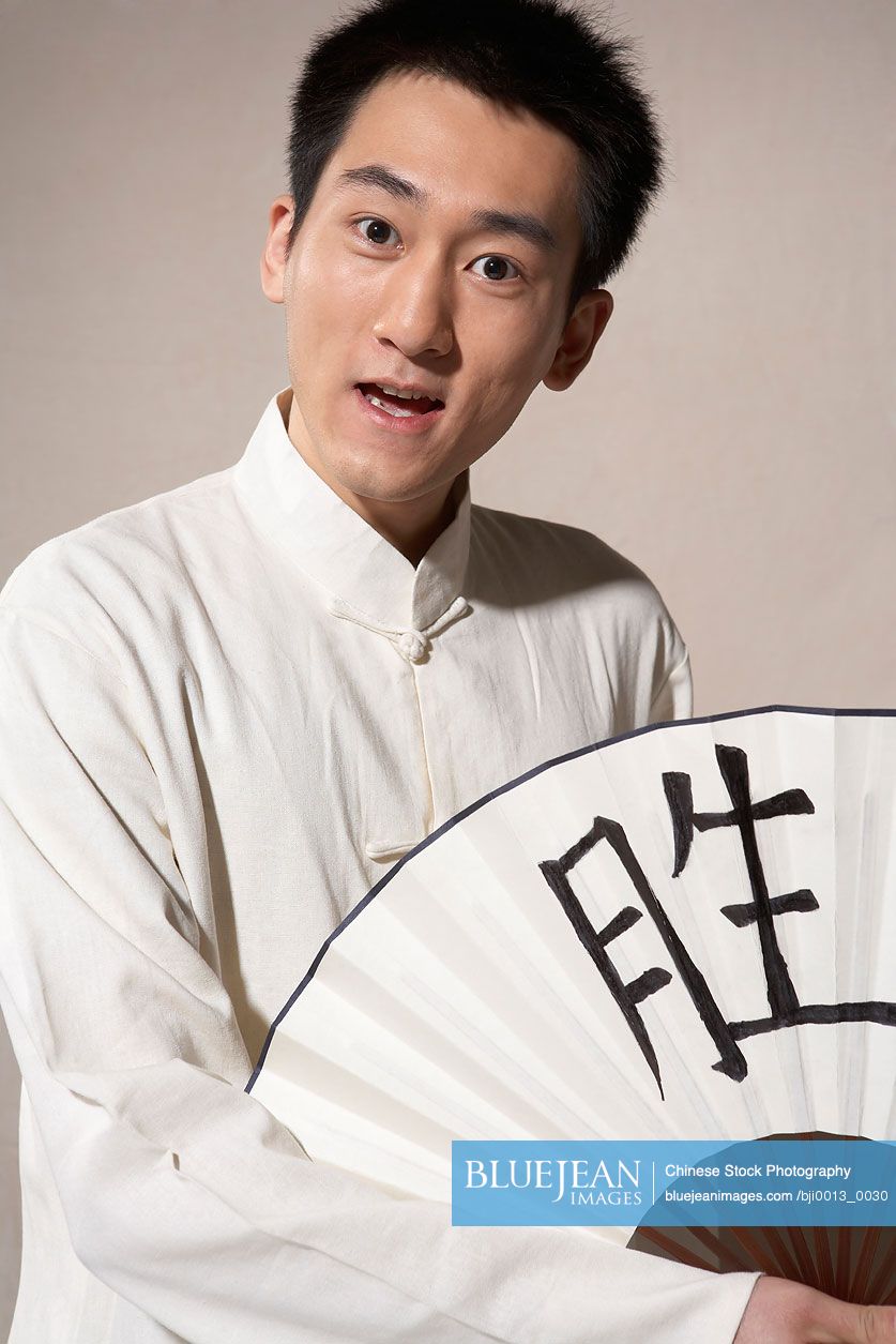 Chinese Man Holding A White Fan