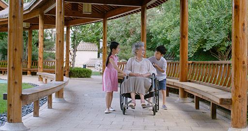 Chinese grandchildren pushing grandmother in wheelchair,4K