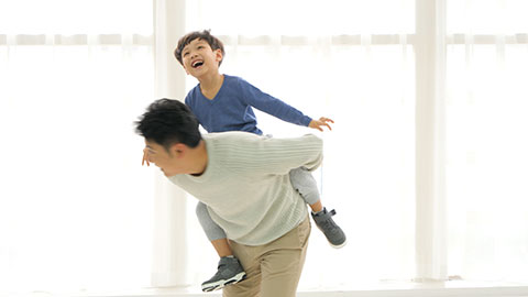 Chinese father and son playing in living room,4K