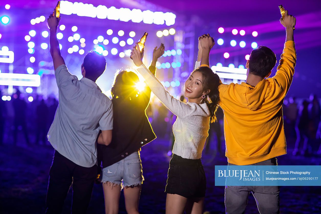 Happy young Chinese friends at music festival