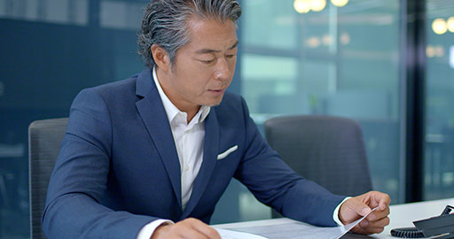 Successful Chinese businessman reading file,4K