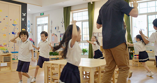 Teachers and children playing games in kindergarten classroom,4K