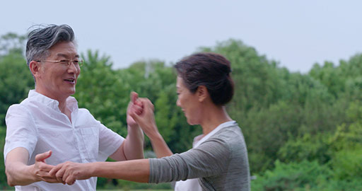 Happy senior Chinese couple dancing in park,4K