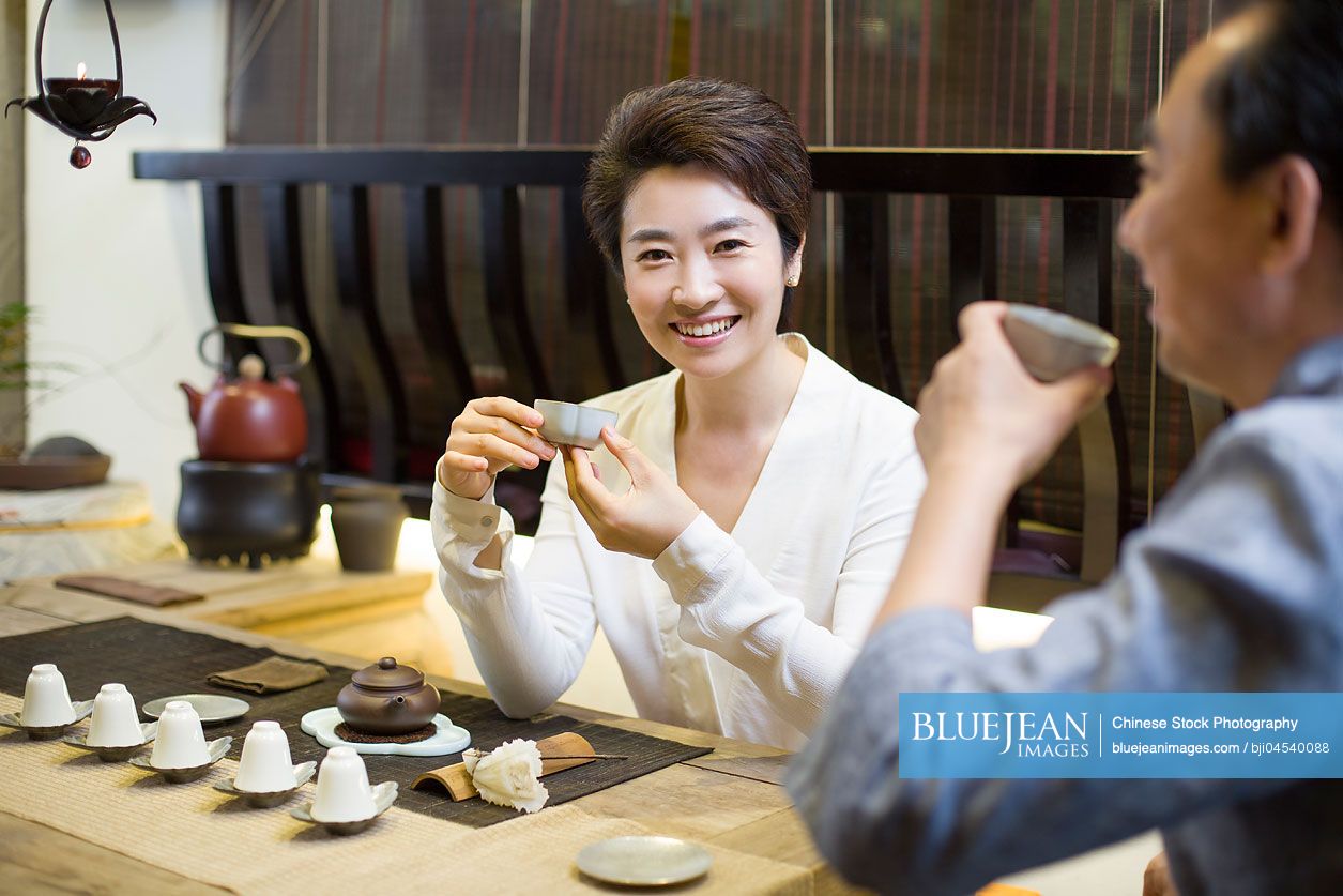 Chinese friends drinking tea and talking in tea room