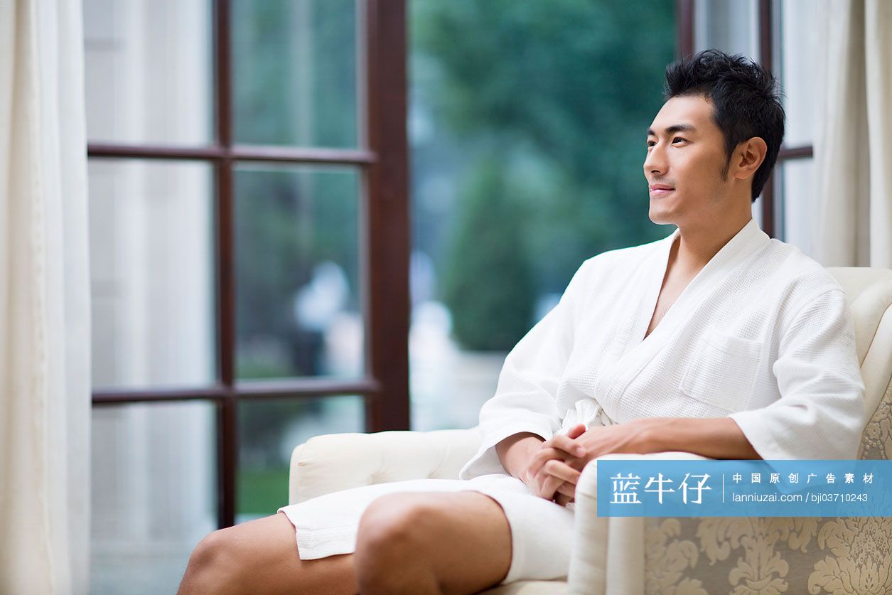 坐在沙发上的年轻男子