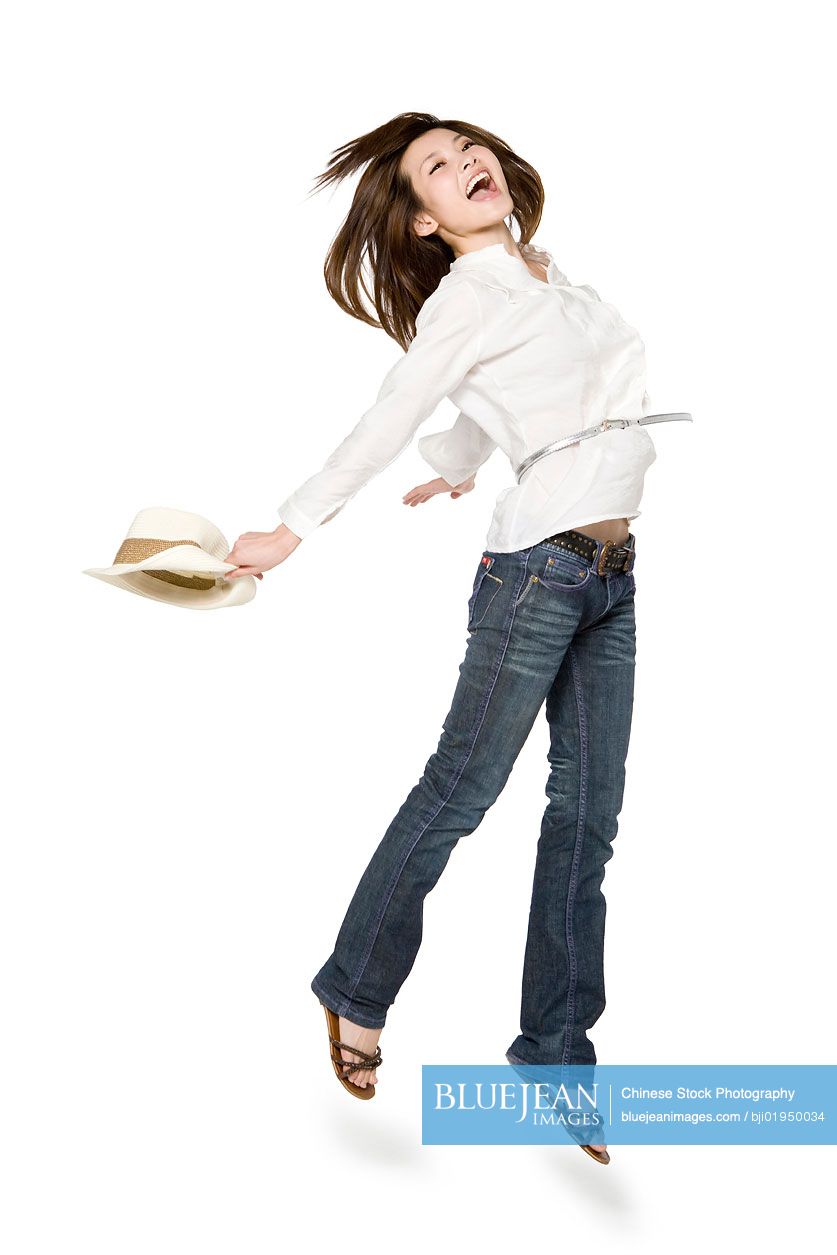 Portrait of young Chinese woman jumping