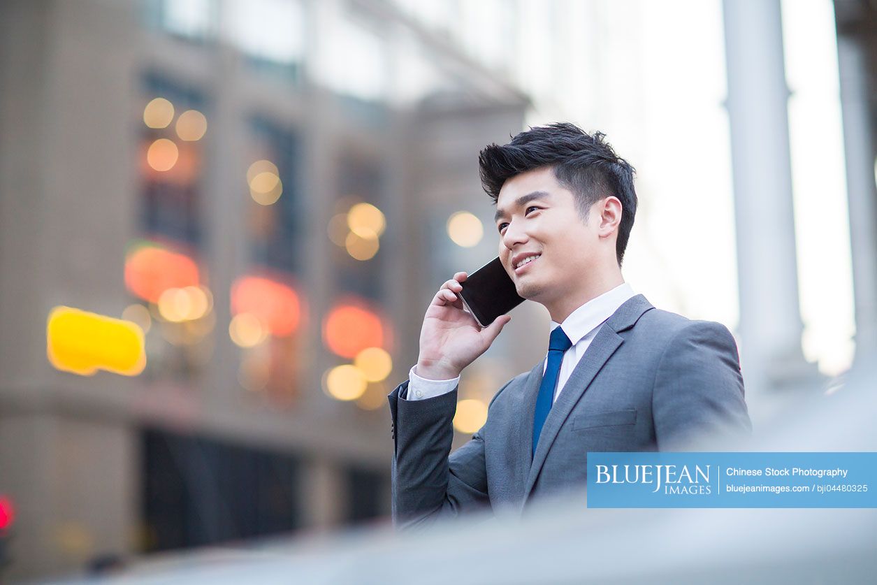 Young Chinese businessman talking on the phone