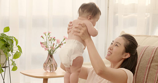 Young Chinese mom holding baby girl up,4K