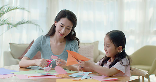 Happy Chinese mother and daughter making cards at home,4K