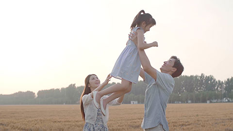 Happy young Chinese family having fun in wheat field,HD