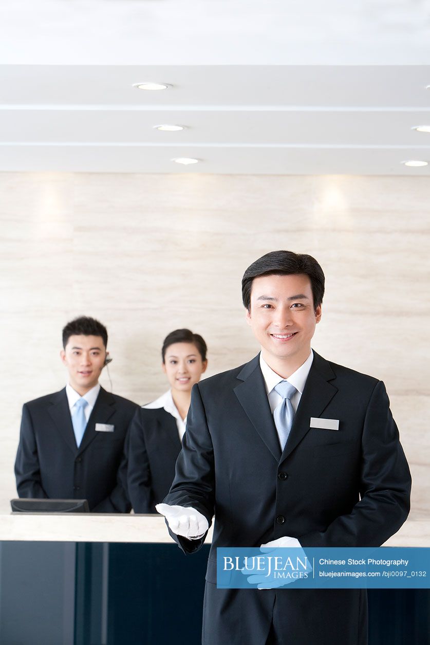 Chinese Concierge With Hotel Staff