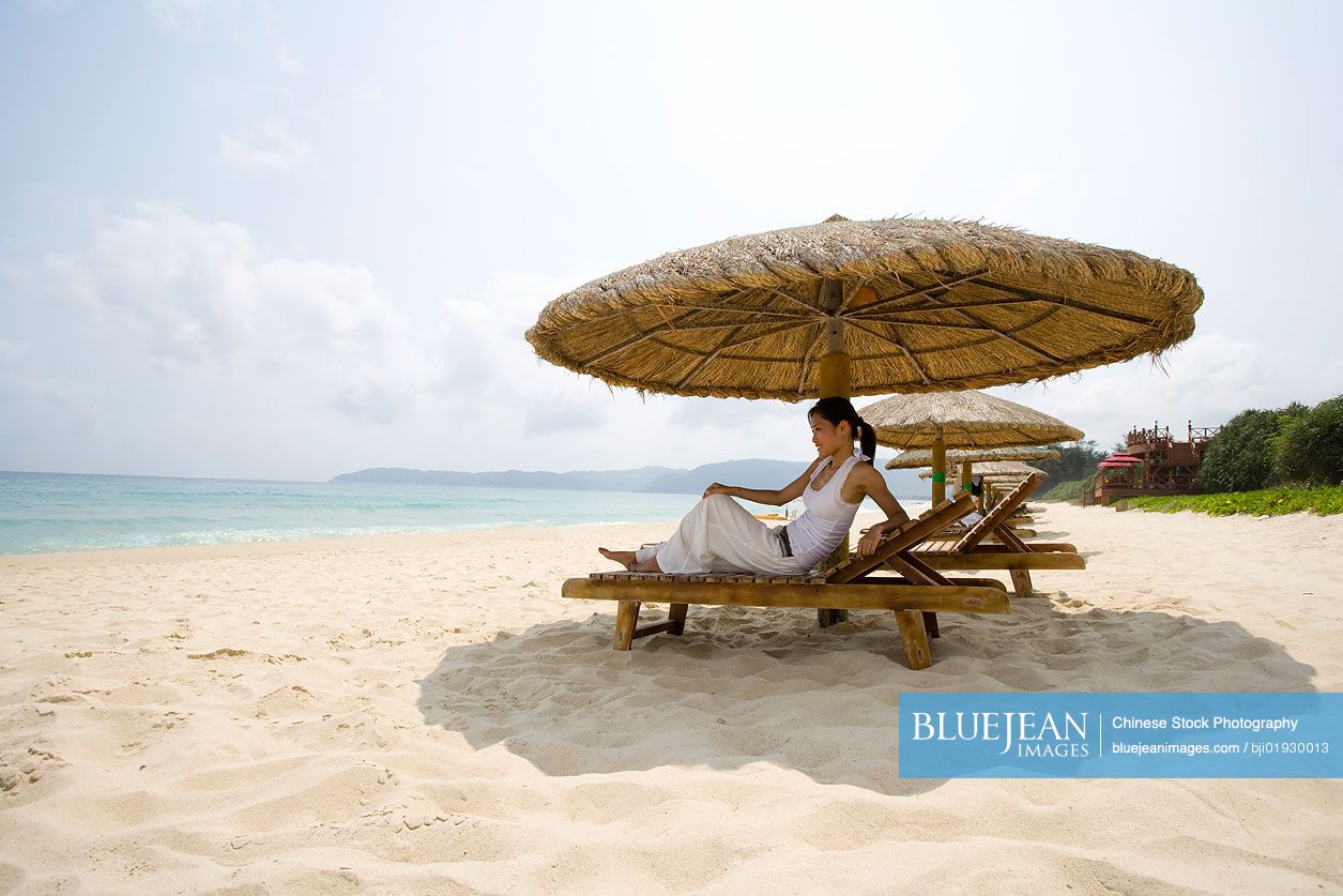 Young Chinese woman relaxing on the beach