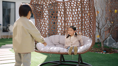 Happy little Chinese children relaxing on hanging-chair,4K