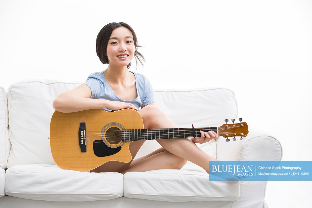 Young Chinese woman and guitar