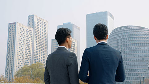 Confident Chinese business people talking outdoors