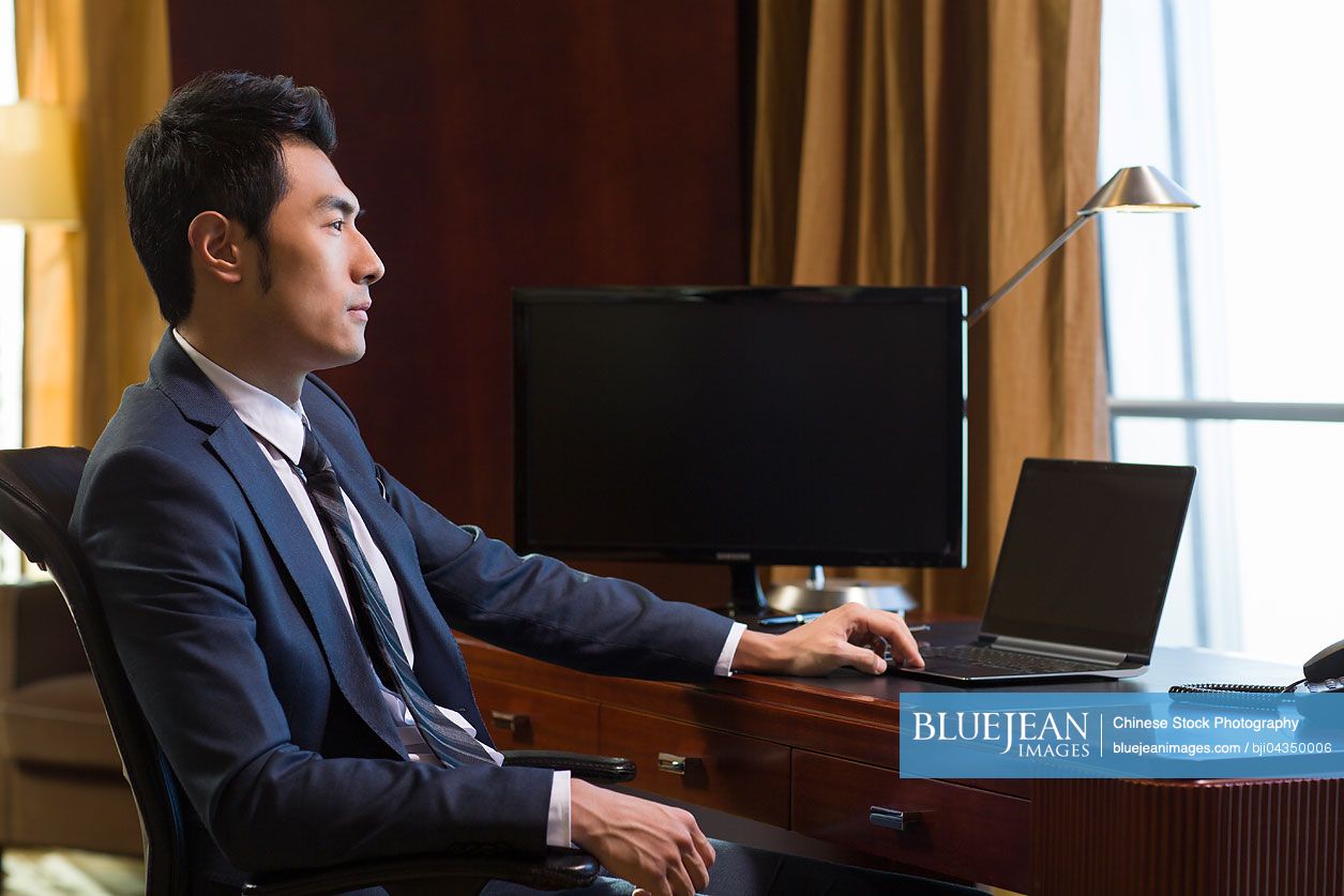 Successful Chinese businessman thinking in study