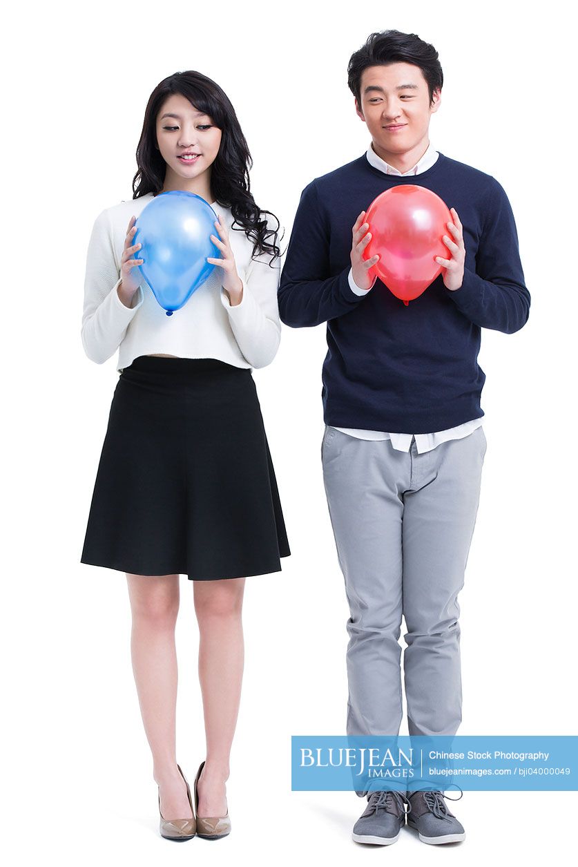 Happy young Chinese couple with balloons