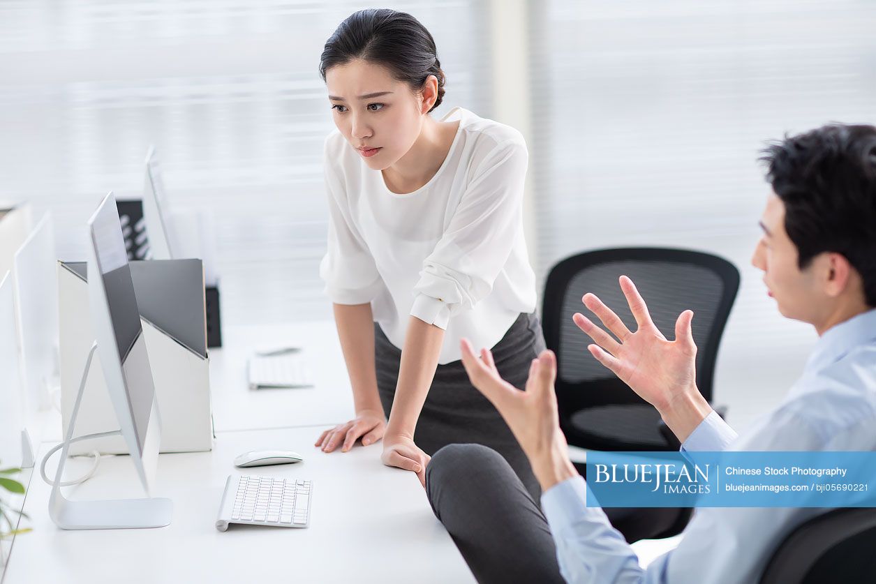 Young Chinese business people working in office