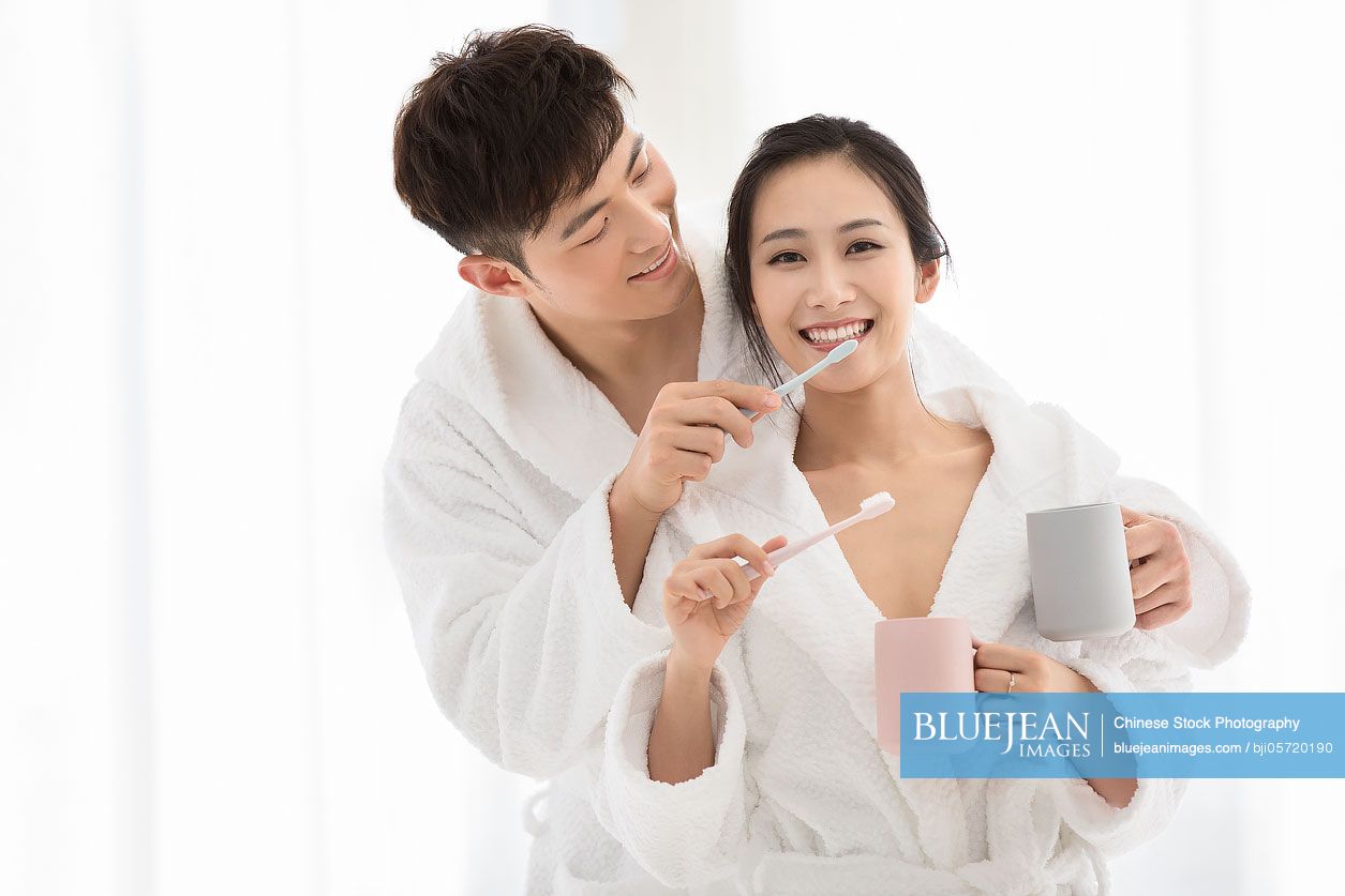 Young chinese couple brushing teeth at home high res stock photo for