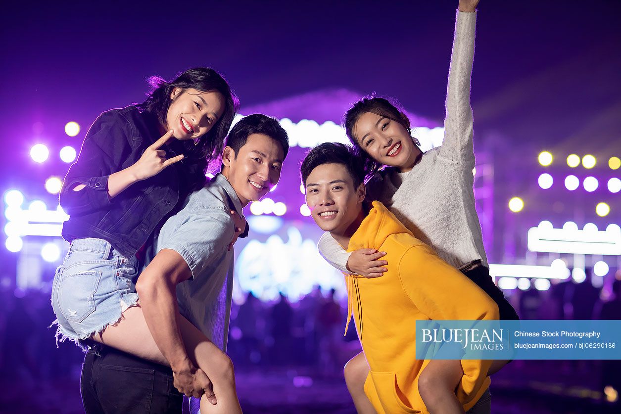 Happy young Chinese friends at music festival