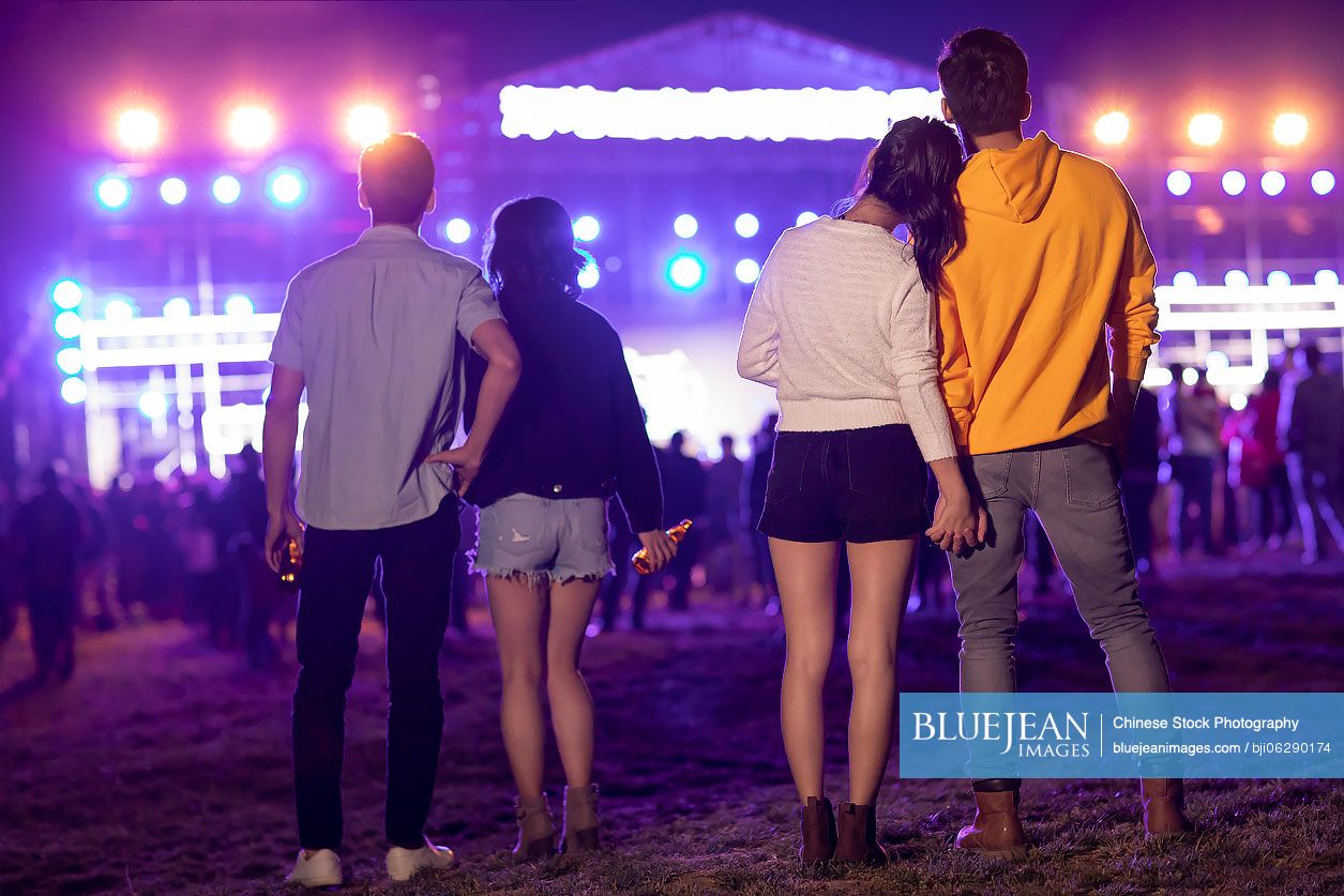Happy young Chinese friends at music festival
