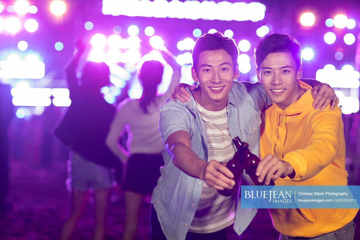 Happy young Chinese friends at music festival