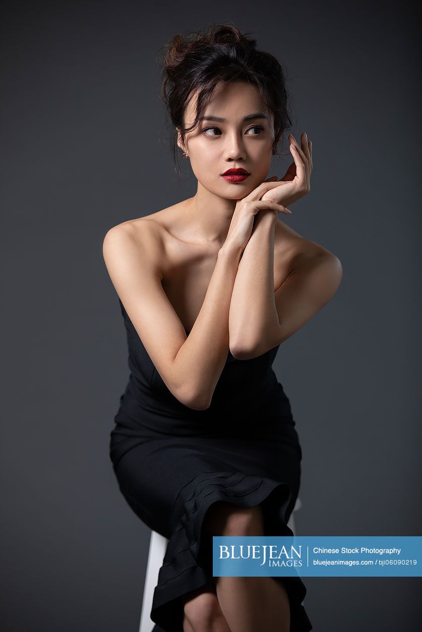 Beautiful young Chinese woman in black dress