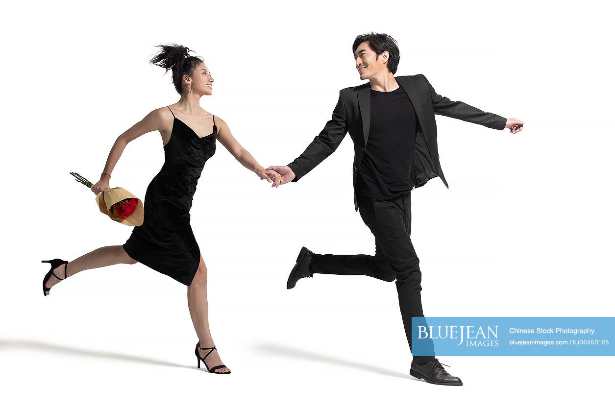 Romantic Chinese couple holding hands running