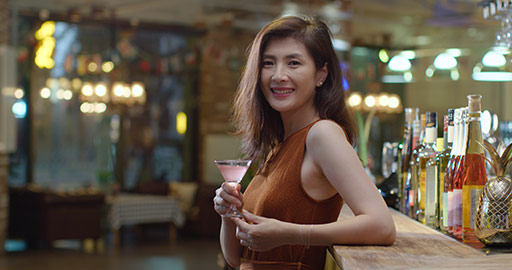 Beautiful Chinese woman drinking cocktail in bar,4K