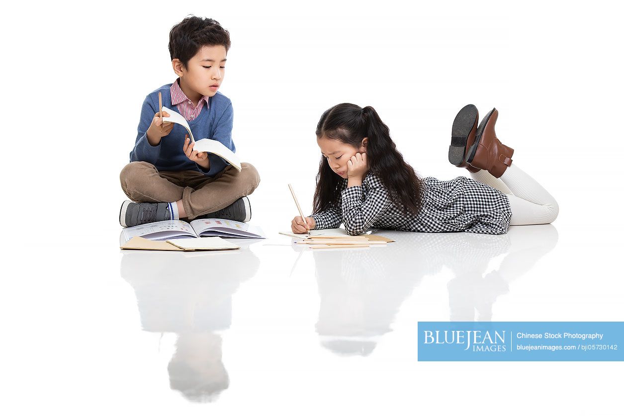 Two Chinese children studying together