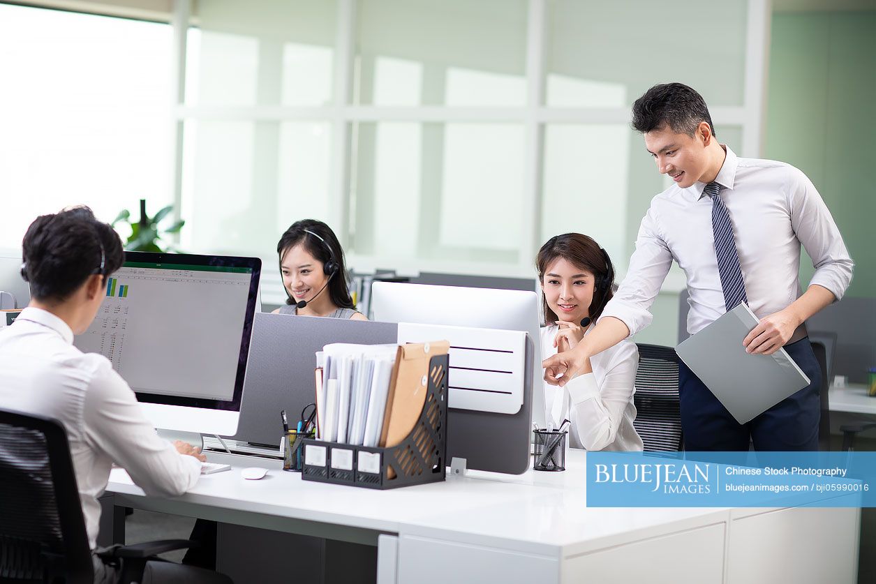 Chinese call center agents working in office