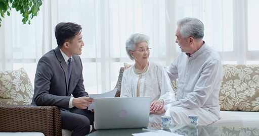 Happy senior Chinese couple talking with financial advisor at home,4K