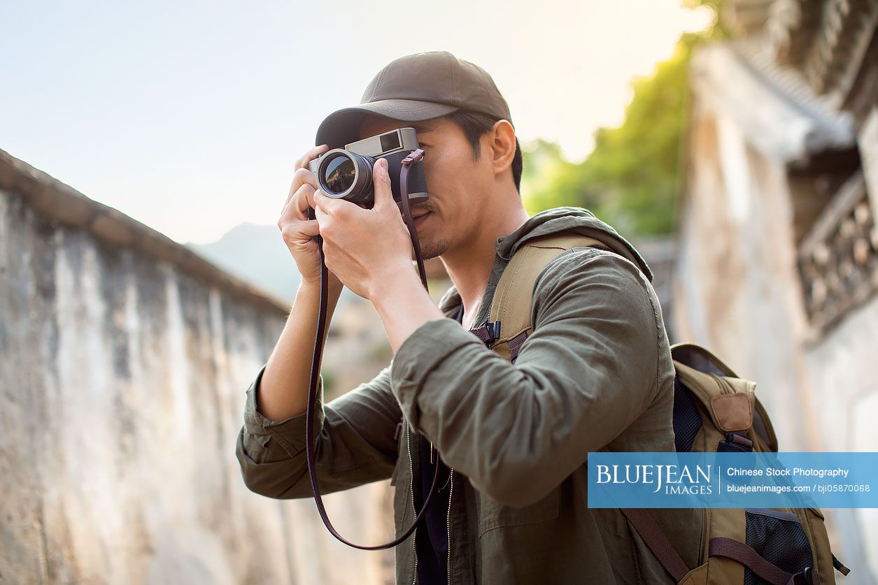 Chinese photographer taking photos in village