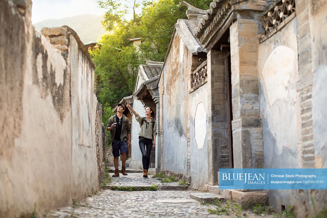 Young Chinese couple hiking in village