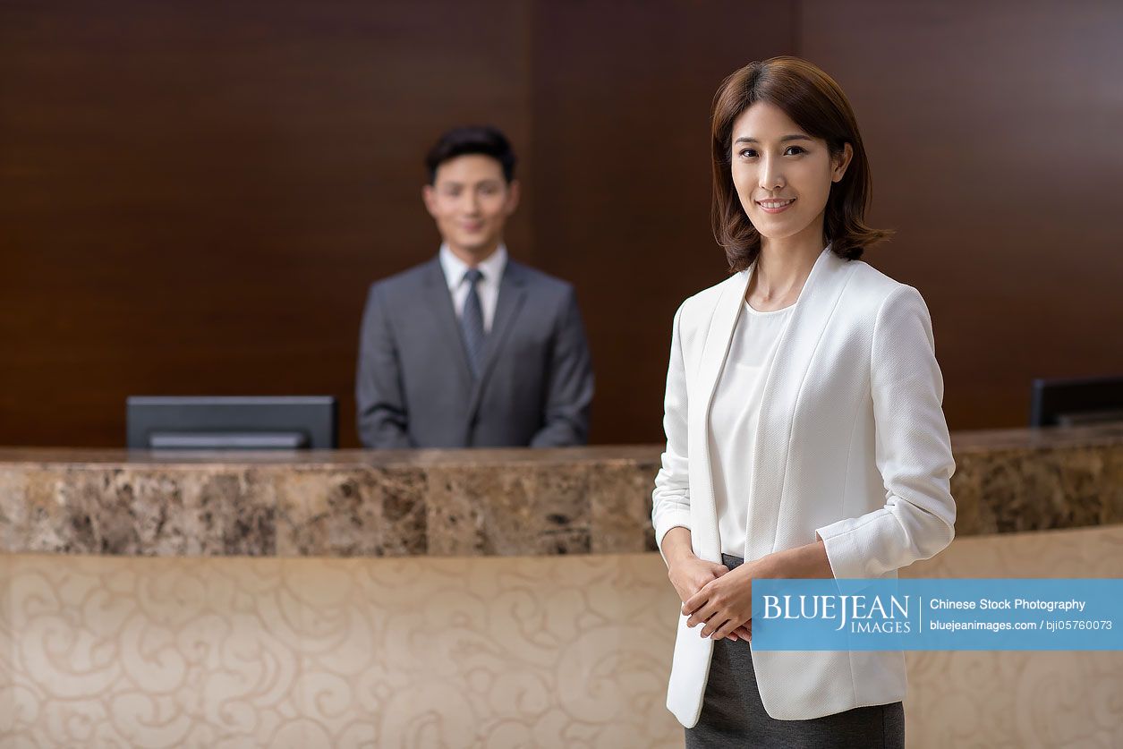 Chinese hotel receptionists at front desk