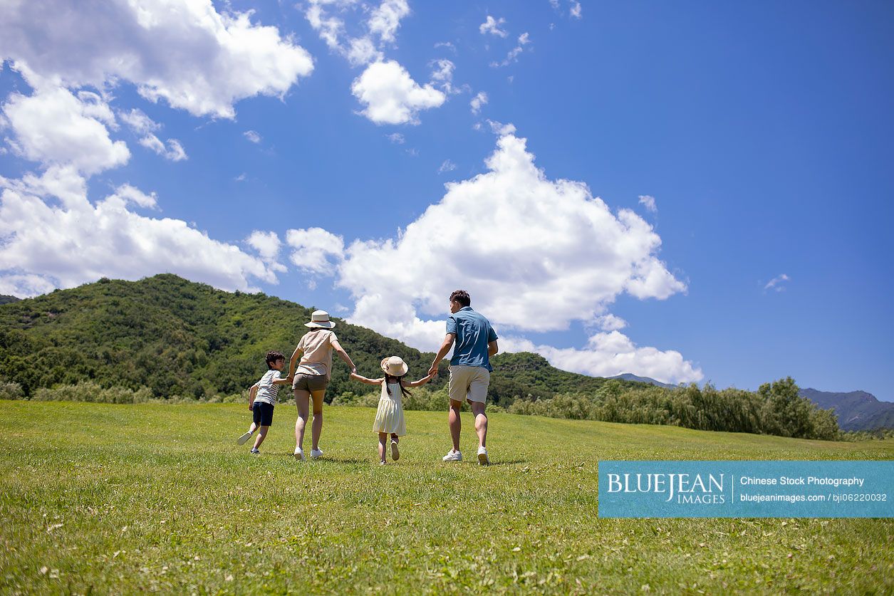 Happy young Chinese family having fun outdoors