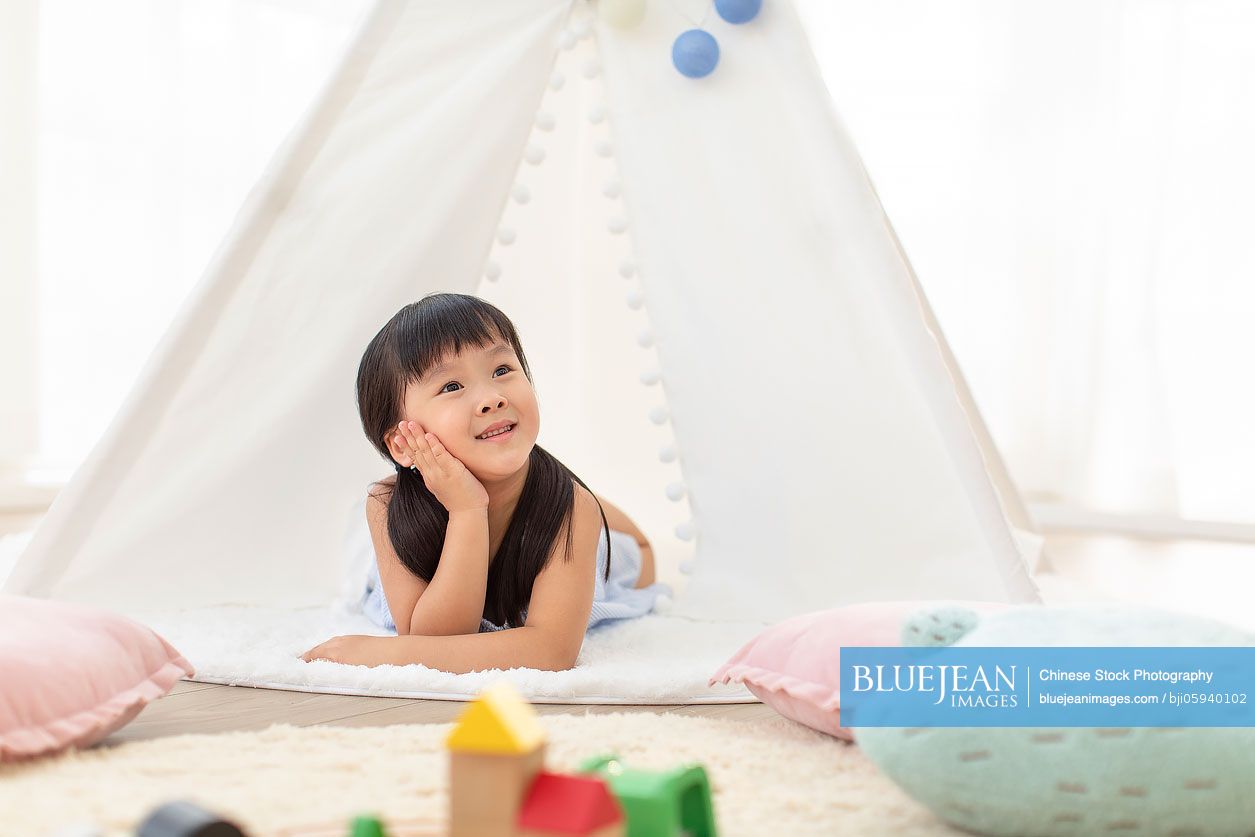 Cute Chinese girl playing in tent