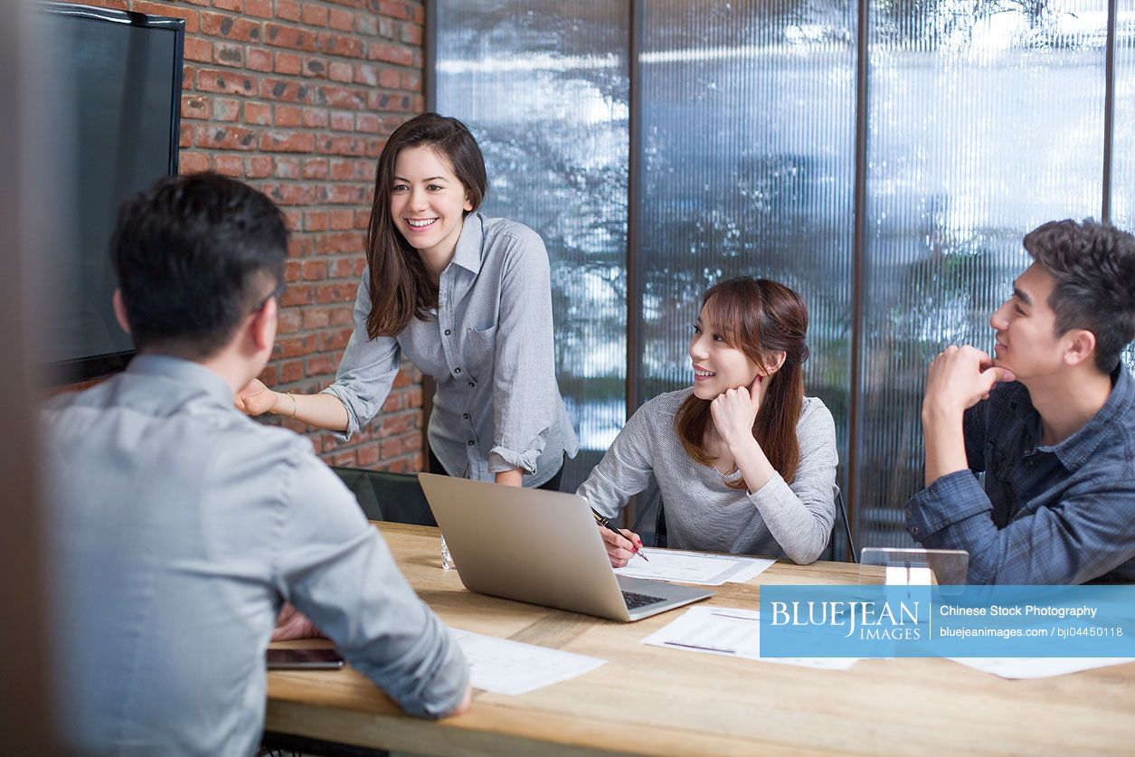 Chinese business people having meeting in board room