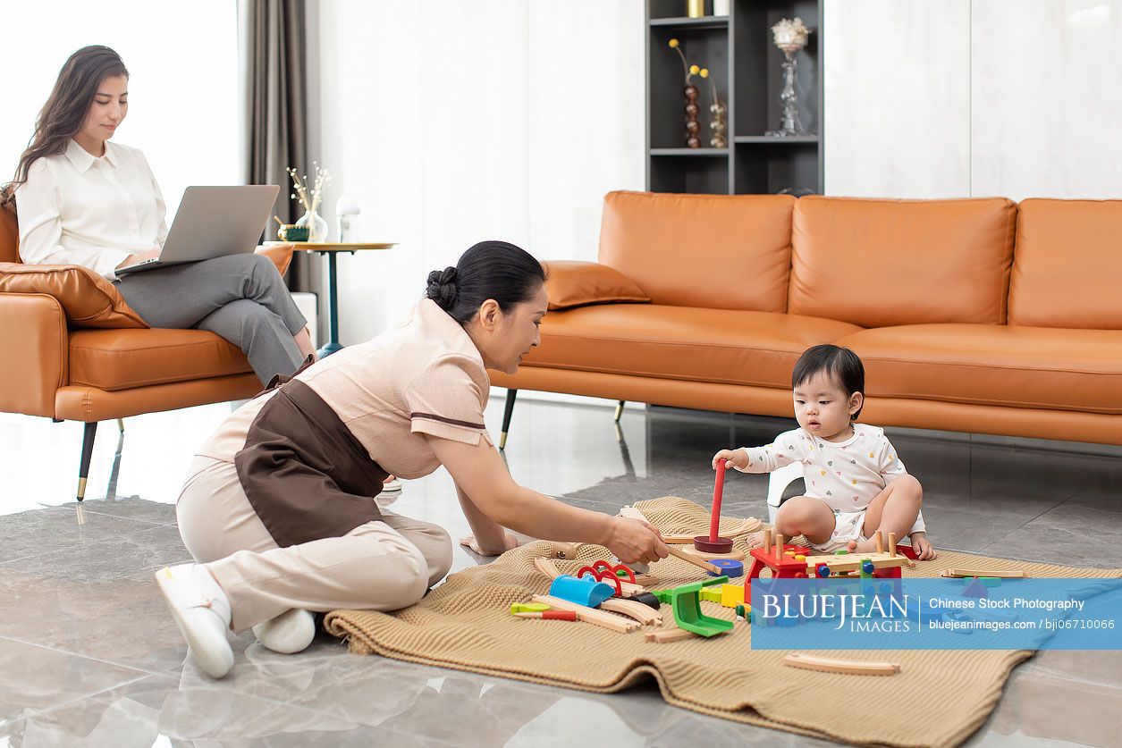 Chinese nanny taking care of baby girl