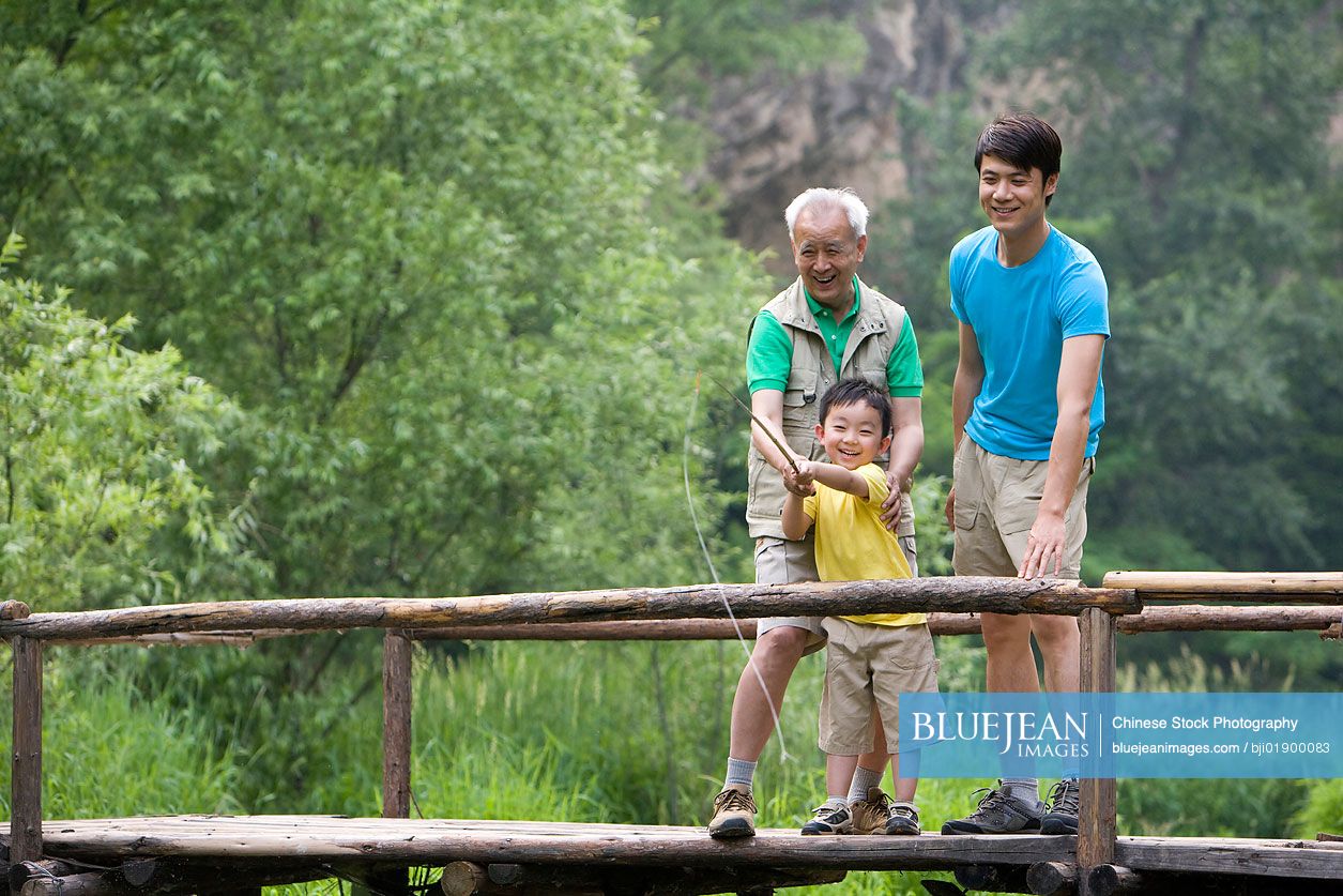 Portrait of three Chinese generations fishing