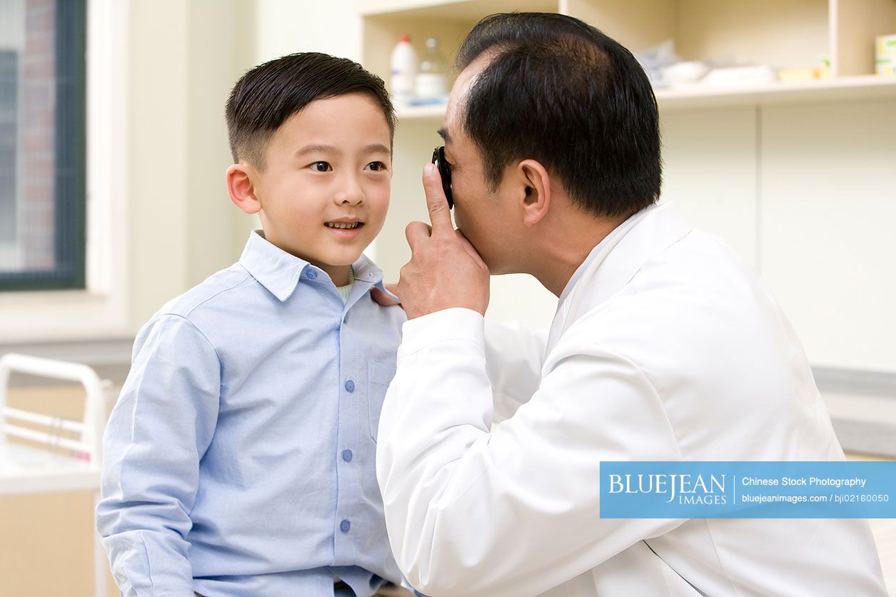 Young Chinese boy examined by a doctor