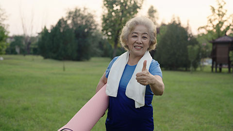 Happy senior Chinese woman exercising in park,4K